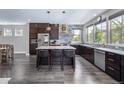 Kitchen with wood floors, a large island with seating and stainless steel appliances at 2592 S Norse Ct, Lakewood, CO 80228