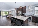 Modern kitchen featuring stainless steel appliances, granite countertops and a large kitchen island at 2592 S Norse Ct, Lakewood, CO 80228