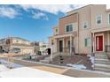 Beautifully landscaped modern townhome with a combination of siding and brick accents on a sunny day at 24501 E 41St Ave, Aurora, CO 80019