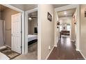 Hallway with hardwood floors leading to a bedroom and living area, offering a view of the home's layout at 19468 E 65Th Pl, Aurora, CO 80019