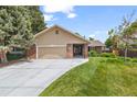 Charming exterior of a home with a lush green lawn and a driveway leading to an attached garage at 37 E 14Th Pl, Broomfield, CO 80020
