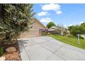Charming exterior of a home with a lush green lawn and a long driveway leading to an attached garage at 37 E 14Th Pl, Broomfield, CO 80020