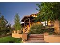 Beautiful home exterior showcasing a cozy porch with stairs, a stone path, and lovely foliage at 722 Evening Star Dr, Castle Rock, CO 80108