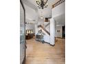 Bright and welcoming foyer featuring gleaming wood floors, soaring ceilings, and a wooden staircase at 722 Evening Star Dr, Castle Rock, CO 80108