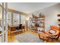 Home office features hardwood floors, built-in shelving and a comfortable armchair at 2059 S Columbine St, Denver, CO 80210
