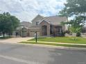 Lovely two-story home with a stone-accented entrance, three-car garage, and neatly manicured lawn at 14096 Roaring Fork Cir, Broomfield, CO 80023