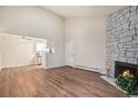 Open-concept living area features a decorative stone fireplace, and an adjacent kitchen area at 10150 E Virginia Ave # 7-304, Denver, CO 80247