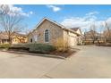 Home with unique stone exterior, a well-maintained yard, and a spacious driveway leading to the garage at 1133 Northridge Dr, Erie, CO 80516