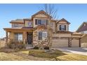 Charming two-story home with a stone facade, three-car garage, well-kept landscaping, and covered front porch at 8768 Foxfire St, Firestone, CO 80504