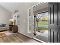 Bright entryway with hardwood floors, a vaulted ceiling, and a view of the front porch at 20650 Parker Vista Cir, Parker, CO 80138