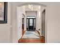 Elegant entryway with hardwood floors and black door at 9965 E 143Rd Way, Brighton, CO 80602