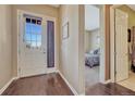 Welcoming entryway featuring hardwood floors, natural light, and views into the bedroom at 12732 Fisher Dr, Englewood, CO 80112