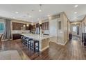 Spacious kitchen with dark cabinets, a large island, and stainless steel appliances at 12732 Fisher Dr, Englewood, CO 80112