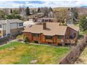 Backyard with mature landscaping and a cozy deck, perfect for outdoor entertaining and enjoying the serene surroundings at 11875 W 107Th Ave, Broomfield, CO 80021