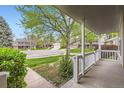 Inviting porch view showcases the tranquil neighborhood and mature trees at 6432 E Jamison Cir, Centennial, CO 80112