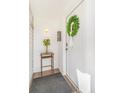 Bright foyer featuring white walls, wood floors, and a welcoming wreath on the door at 821 Collyer St, Longmont, CO 80501