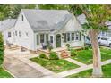 Charming home exterior with a well-maintained lawn, mature trees, and a quaint front porch perfect for relaxing at 821 Collyer St, Longmont, CO 80501