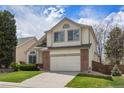 Traditional two-story home with attached garage, well-maintained lawn, and tasteful landscaping at 8985 Edgewood Ln, Highlands Ranch, CO 80130