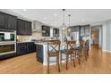 Modern eat-in kitchen features a large island, granite countertops, and stainless steel appliances at 26566 E Peakview Dr, Aurora, CO 80016