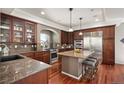 Well-appointed kitchen with granite countertops, an island with seating, and stainless steel appliances at 4913 Cathay Ct, Denver, CO 80249