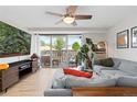 Inviting living room with a cozy gray couch, balcony access, and entertainment center with a large screen TV at 1150 Vine St # 306, Denver, CO 80206