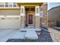 Close-up of the inviting front entrance with stone columns at 9334 Sedalia St, Commerce City, CO 80022
