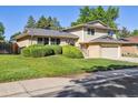 Charming two-story home with a manicured lawn and mature trees at 2931 S Sidney Ct, Denver, CO 80231