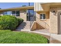 Close up of the front entrance with brick work and well maintained lawn at 2931 S Sidney Ct, Denver, CO 80231