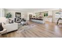 Open concept living room with a large island and bar stool seating at 2931 S Sidney Ct, Denver, CO 80231