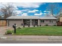 Charming single-story home with an inviting front yard, well-manicured lawn, and mature trees at 8151 S Marshall Ct, Littleton, CO 80128