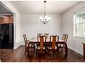 Dining room showcasing a classic chandelier, hardwood floors and marble tabletop, next to the kitchen at 42425 Forest Oaks Dr, Elizabeth, CO 80107