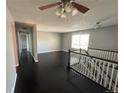 Open living room featuring a ceiling fan and staircase with white wood railing at 1592 S Memphis St, Aurora, CO 80017