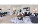 Open concept living area flowing into a kitchen with hardwood floors, modern furniture, and stylish decor at 2120 W 31St Ave, Denver, CO 80211