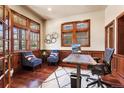 Cozy home office featuring wood trim, large windows, hardwood floors, and comfortable seating at 2486 S Monroe St, Denver, CO 80210