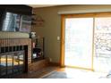 A cozy living room with a brick fireplace, sliding glass door, and outside views at 155 Xenon St # 33, Denver, CO 80228