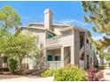 Attractive condo building featuring multiple units, exterior stairs, charming balconies, and well-maintained landscaping at 8405 Pebble Creek Way # 202, Highlands Ranch, CO 80126