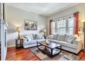 Bright living room featuring hardwood floors, comfortable seating, and large windows with natural light at 10152 Inverness Main St, Englewood, CO 80112