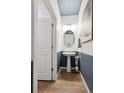 Modern powder room with a pedestal sink and stylish decor at 43074 Merion Hills Ct, Elizabeth, CO 80107