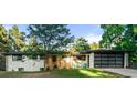 Charming single-story home with a brick facade, glass-paneled garage, and a well-manicured front lawn at 1920 S Niagara St, Denver, CO 80224