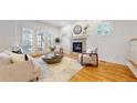 Bright living room with fireplace, hardwood floors, and stylish furnishings at 203 S Jackson St, Denver, CO 80209