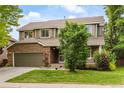 Charming two-story home with brick and siding, well-maintained lawn, and an attached two-car garage at 10284 Royal Eagle St, Highlands Ranch, CO 80129