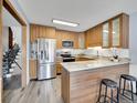 Modern kitchen with stainless steel appliances and breakfast bar at 2665 S Sheridan Ct, Lakewood, CO 80227