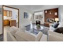 Living room with fireplace and view into updated kitchen at 2665 S Sheridan Ct, Lakewood, CO 80227