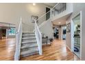 Bright foyer with hardwood floors and stairway leading to second floor at 6526 S Killarney Ct, Aurora, CO 80016