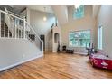 Sun-filled open living space with soaring ceiling, hardwood floors and large windows at 6526 S Killarney Ct, Aurora, CO 80016