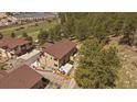 Backyard aerial view with small turf area, fenced yard and outdoor seating at 726 Dreamcatcher Ln, Evergreen, CO 80439