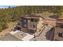 Modern townhome exterior with an attached two-car garage and concrete driveway at 726 Dreamcatcher Ln, Evergreen, CO 80439