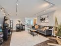 Inviting living room with a comfortable sofa, unique art, and a dining area in the background at 1155 Ash St # 202, Denver, CO 80220