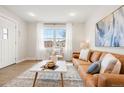 Bright and airy living room with large window, white walls, and neutral tones creating a comfortable atmosphere at 1805 W 51St Ave, Denver, CO 80221