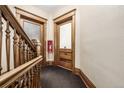 Hallway with wood trim, doors, and fire extinguisher at 1210 E Colfax Ave # 301, Denver, CO 80218